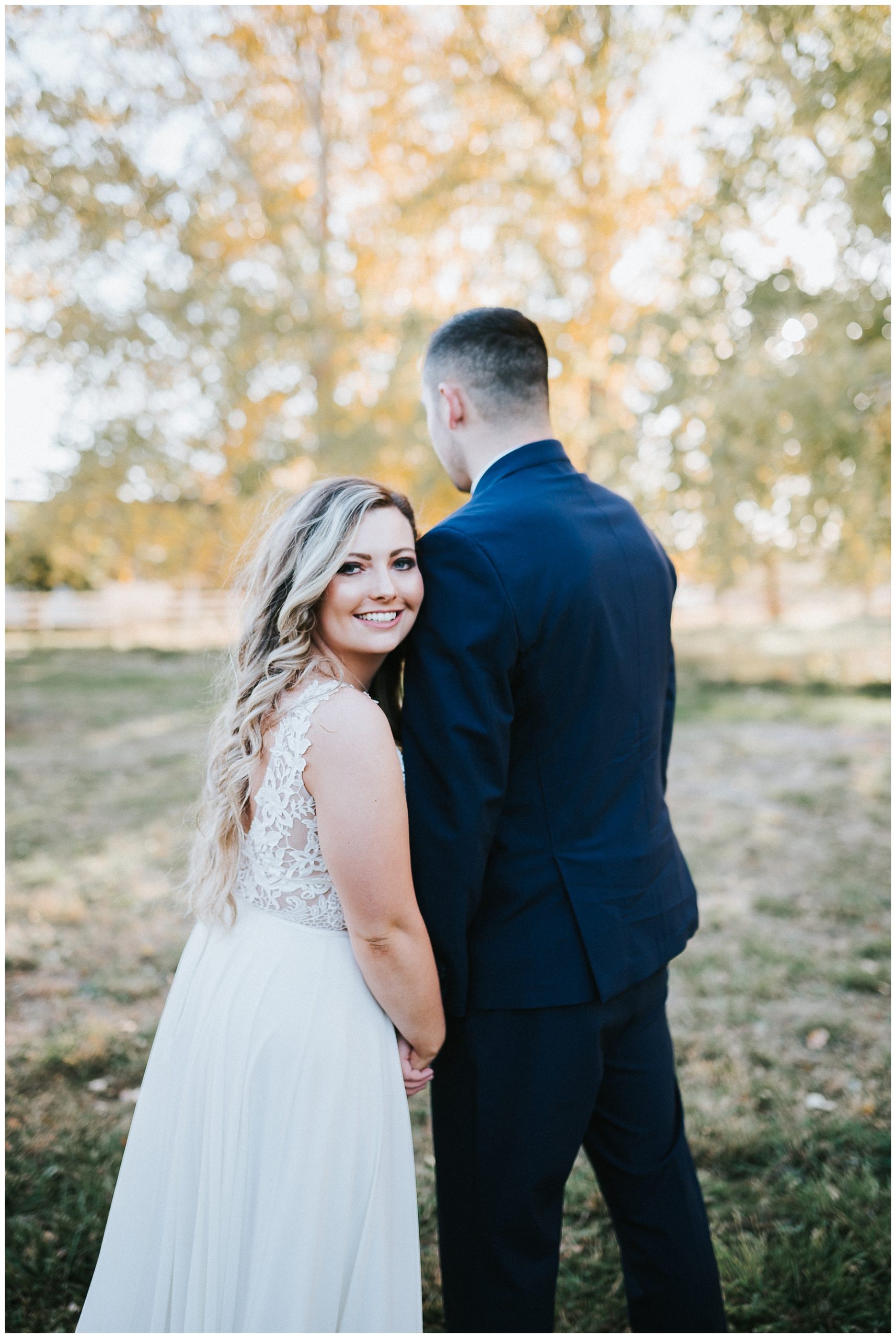 boho-bride-and-groom-long-wedding-dress-with-train-bride-and-groom-flowy-wedding-dress-fall-wedding-twin-falls-idaho-wedding-photographer-wedding-in-apple-orchard-finch-film-and-photo