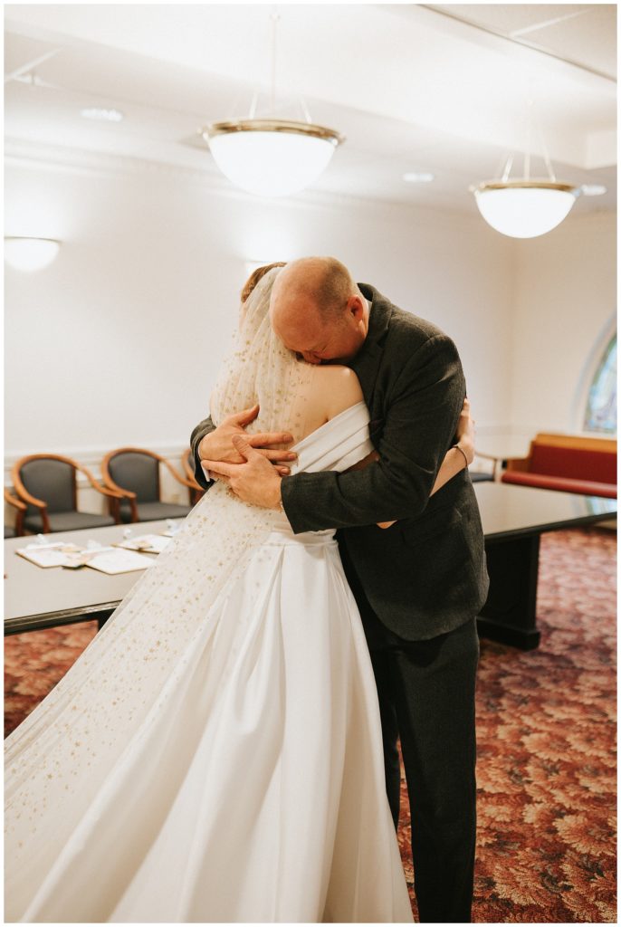 dad has first look with bride and tearfully hugs her